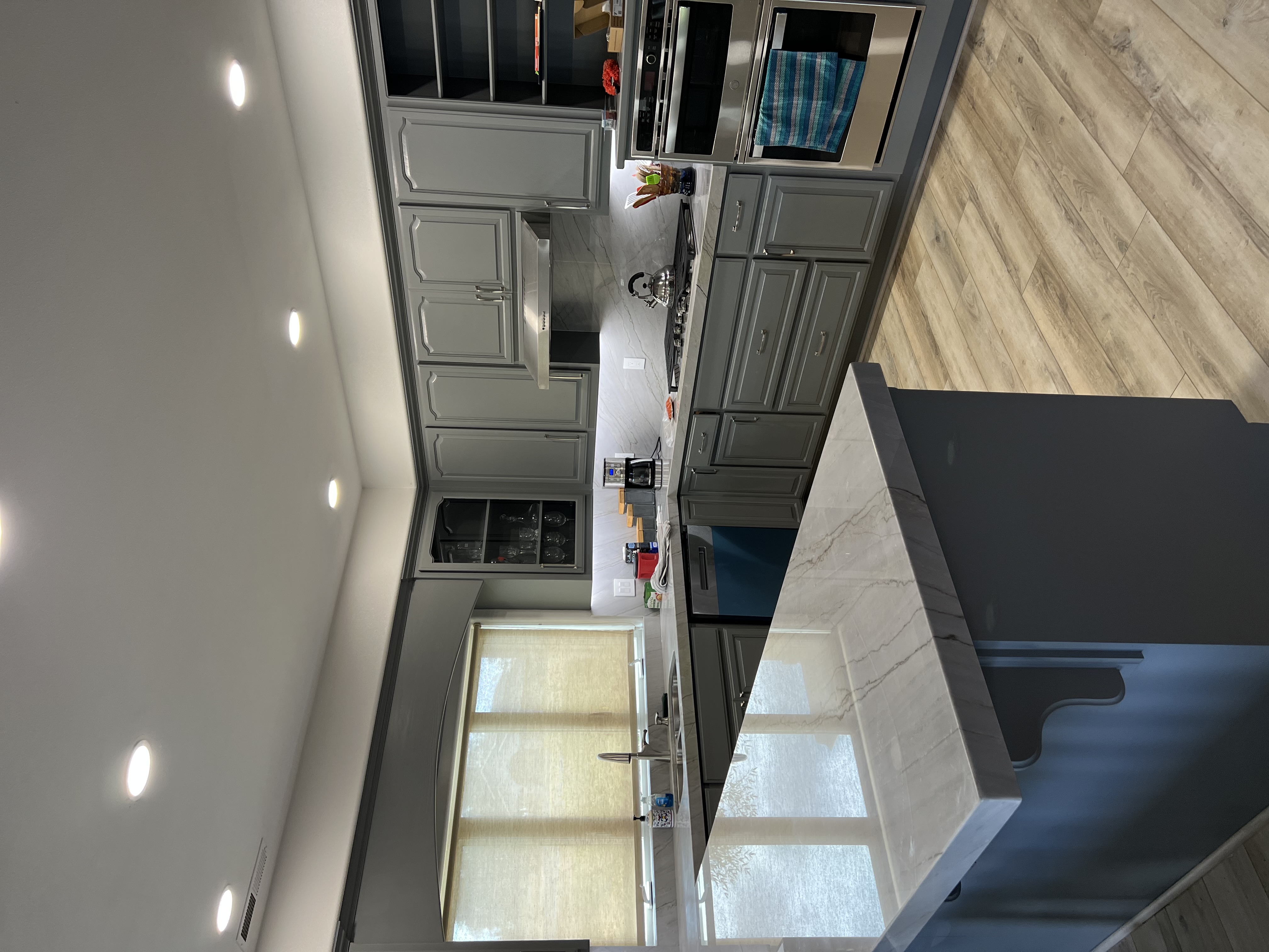 Modern kitchen remodel with custom cabinetry, quartz countertops, and stainless steel appliances